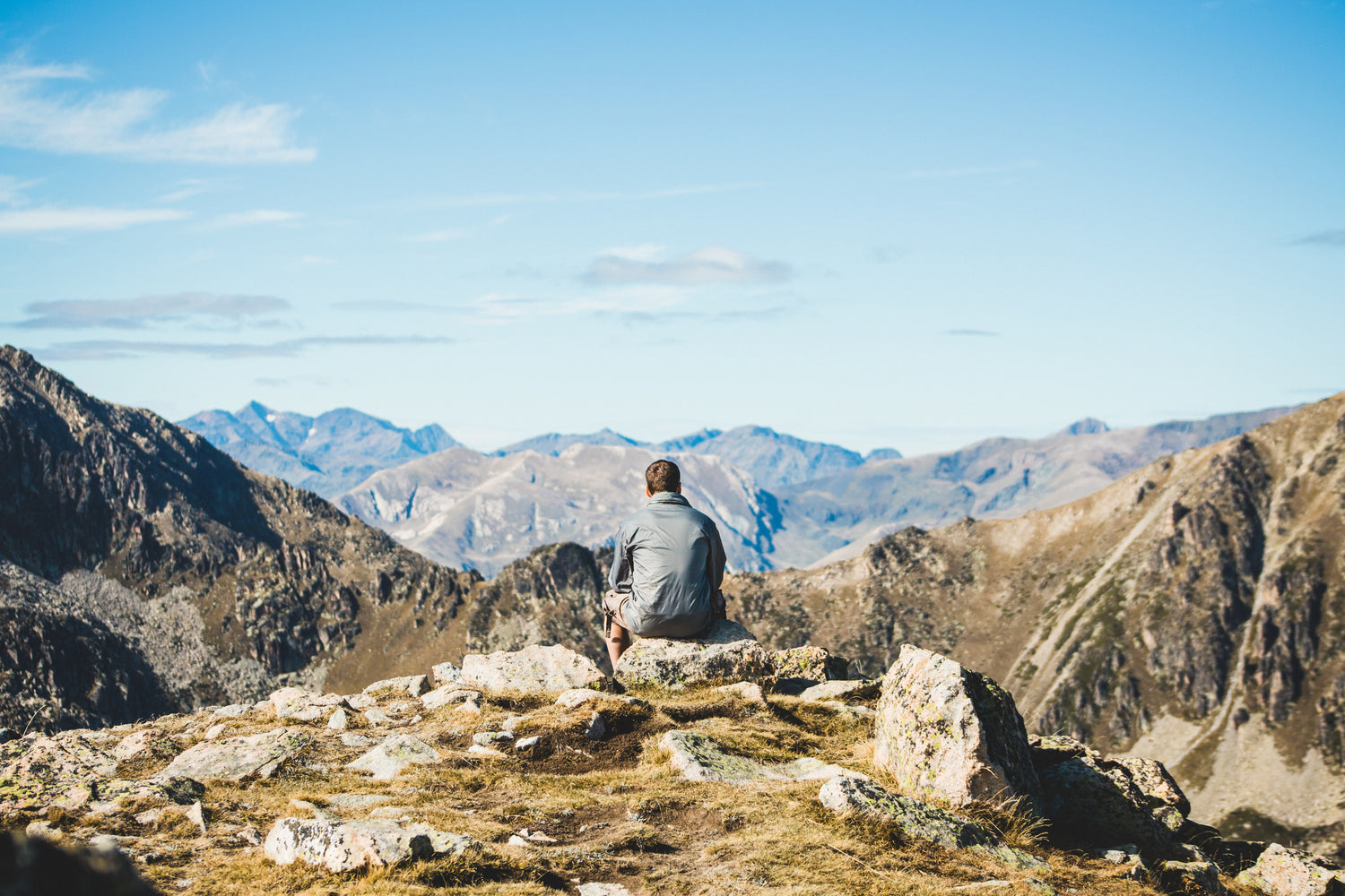 Person enjoying a peaceful mountain landscape, representing outdoor exploration and adventure lifestyle
